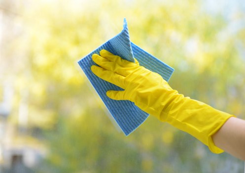 Team member preparing cleaning tools and PPE before starting work