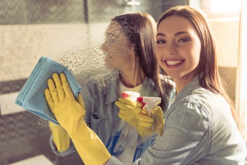 Office cleaner in Westminster sanitising a workspace